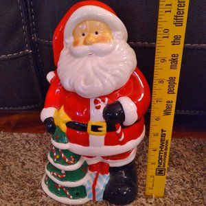 christmas. santa standing next to xmas tree cookie jar